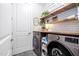 Well-organized laundry room featuring modern washer and dryer units, ample counter space, and stylish decor at 105 Olde Liberty Dr, Youngsville, NC 27596