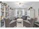 Cozy living room with built-in bookcase, comfortable seating, and a stylish ottoman at 105 Olde Liberty Dr, Youngsville, NC 27596