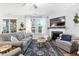 Spacious living room features large windows, fireplace and hardwood floors, offering ample natural light and a welcoming ambiance at 105 Olde Liberty Dr, Youngsville, NC 27596