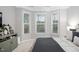 A bright main bedroom with a large bay window and neutral walls and carpet at 105 Olde Liberty Dr, Youngsville, NC 27596