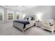 Comfortable main bedroom features neutral paint, a large bed, and lots of natural light at 105 Olde Liberty Dr, Youngsville, NC 27596