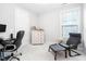 Cozy home office with comfortable seating, neutral walls, and a bright window for natural light at 105 Olde Liberty Dr, Youngsville, NC 27596