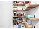 Well-organized pantry featuring wooden shelving and a variety of appliances and food items at 105 Olde Liberty Dr, Youngsville, NC 27596