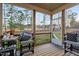 Relaxing screened porch features wooden floors, comfortable seating, and views of the backyard, perfect for outdoor living at 105 Olde Liberty Dr, Youngsville, NC 27596