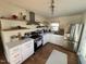 Modern kitchen with white countertops, stainless steel appliances, open shelving, and a window at 106 Eugene St, Carrboro, NC 27510