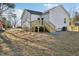 Backyard view featuring a new wooden deck and newly seeded lawn at 109 Faucette Ave, Burlington, NC 27215