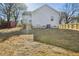 View of the home's backyard with new siding, deck, and wooden fence at 109 Faucette Ave, Burlington, NC 27215
