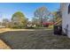 Expansive backyard view showing a lawn and various trees at 109 Faucette Ave, Burlington, NC 27215