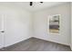 Bright bedroom features a ceiling fan, wood-look flooring, and a window providing natural light at 109 Faucette Ave, Burlington, NC 27215