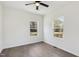 This bedroom features neutral walls, wood-look flooring, two windows, and a ceiling fan at 109 Faucette Ave, Burlington, NC 27215