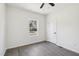 This bedroom features neutral walls, wood-look flooring, a window, and a ceiling fan at 109 Faucette Ave, Burlington, NC 27215