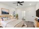 A stylish staged bedroom features wood-look floors, ensuite, and a large window at 109 Faucette Ave, Burlington, NC 27215