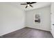 Bedroom featuring wood-look floors, white walls, window, and ceiling fan at 109 Faucette Ave, Burlington, NC 27215