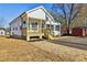 Well-kept single-story home featuring a inviting wooden porch and a neatly maintained yard at 109 Faucette Ave, Burlington, NC 27215