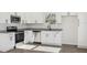 Stylish kitchen equipped with stainless steel appliances, granite countertops, and bright white cabinetry at 109 Faucette Ave, Burlington, NC 27215