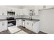 Modern kitchen with stainless steel appliances, granite countertops, ample white cabinetry, and natural light at 109 Faucette Ave, Burlington, NC 27215