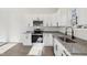Modern kitchen with stainless steel appliances, granite countertops, and sleek white cabinetry at 109 Faucette Ave, Burlington, NC 27215