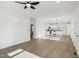 Open floor plan with light wood floors connecting living area and kitchen with stainless steel appliances at 109 Faucette Ave, Burlington, NC 27215