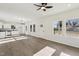 Living room with open floor plan, light wood floors, kitchen with stainless steel appliances, and ample natural light at 109 Faucette Ave, Burlington, NC 27215