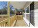 Covered front porch with wooden railings offers a perfect spot for outdoor relaxation at 109 Faucette Ave, Burlington, NC 27215