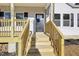 Close-up view of the charming wooden front porch with newly installed steps at 109 Faucette Ave, Burlington, NC 27215