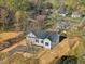 Charming home featuring black shutters, asphalt driveway, and construction in a wooded neighborhood at 111 Faucette Ave, Burlington, NC 27215