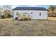 New wooden deck off the back of the house overlooking the straw-covered lawn at 111 Faucette Ave, Burlington, NC 27215