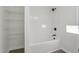 All-white bathroom with bathtub and shower combo at 111 Faucette Ave, Burlington, NC 27215