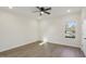 Bright bedroom featuring a ceiling fan, window, and wood-look flooring at 111 Faucette Ave, Burlington, NC 27215