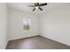 A bright bedroom with ceiling fan and a view from the window at 111 Faucette Ave, Burlington, NC 27215