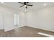 Spacious bedroom with ceiling fan, neutral walls, and wood-look flooring at 111 Faucette Ave, Burlington, NC 27215