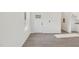 Bright entryway features modern flooring, light walls and a stylish front door at 111 Faucette Ave, Burlington, NC 27215