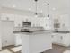 Well-equipped kitchen with a central island, granite countertops, and modern lighting fixtures at 111 Faucette Ave, Burlington, NC 27215