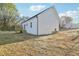 Newly constructed home showcasing a modern exterior, back deck, and ample backyard space at 111 Faucette Ave, Burlington, NC 27215
