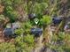 Aerial shot highlights the property's location, nestled among mature trees with a spacious yard and detached shed at 1113 Harvest Mill Ct, Raleigh, NC 27610