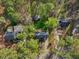Aerial shot showcases the property's layout, nestled among trees with a spacious yard and detached shed at 1113 Harvest Mill Ct, Raleigh, NC 27610
