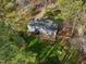 Aerial view showcases the home's backyard, large deck, landscaping, and surrounding trees at 1113 Harvest Mill Ct, Raleigh, NC 27610