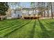 Spacious backyard with lawn, features a wooden deck, ideal for outdoor living at 1113 Harvest Mill Ct, Raleigh, NC 27610