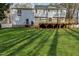Spacious backyard with lawn, features a wooden deck, ideal for outdoor living at 1113 Harvest Mill Ct, Raleigh, NC 27610