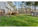 Large grassy backyard featuring the home's rear elevation and a wooden deck at 1113 Harvest Mill Ct, Raleigh, NC 27610