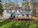 View of backyard featuring large wooden deck and beautiful green lawn, great for entertaining at 1113 Harvest Mill Ct, Raleigh, NC 27610