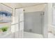 Cozy bathroom featuring a tiled shower and bathtub, a window, and light paint at 1113 Harvest Mill Ct, Raleigh, NC 27610