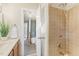Bathroom features a vanity with a sink, shower, and tiled walls at 1113 Harvest Mill Ct, Raleigh, NC 27610