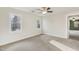 Bedroom featuring neutral carpet, two windows, and ample natural light at 1113 Harvest Mill Ct, Raleigh, NC 27610