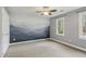 Bedroom featuring a mountain mural, neutral walls, a ceiling fan, and a window at 1113 Harvest Mill Ct, Raleigh, NC 27610
