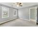 Bedroom with neutral gray walls, light carpet flooring, a ceiling fan, and natural light at 1113 Harvest Mill Ct, Raleigh, NC 27610