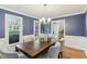 Charming dining room with six chairs, bright windows, a chandelier, and view to staircase at 1113 Harvest Mill Ct, Raleigh, NC 27610