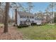 Charming two-story home with black shutters, gray siding, mature trees, and a well-manicured lawn at 1113 Harvest Mill Ct, Raleigh, NC 27610