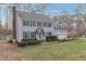 Charming two-story home with black shutters, gray siding, mature trees, and a well-manicured lawn at 1113 Harvest Mill Ct, Raleigh, NC 27610