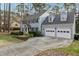 Charming two-story home with black shutters, gray siding, mature trees, and a well-manicured lawn at 1113 Harvest Mill Ct, Raleigh, NC 27610